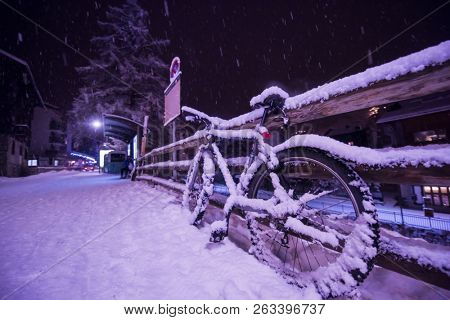 end of biking season.parked bicycle covered by snow from a heavy snowstorm.Winter cycling
