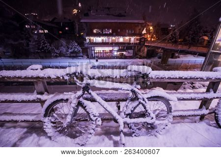 end of biking season.parked bicycle covered by snow from a heavy snowstorm.Winter cycling
