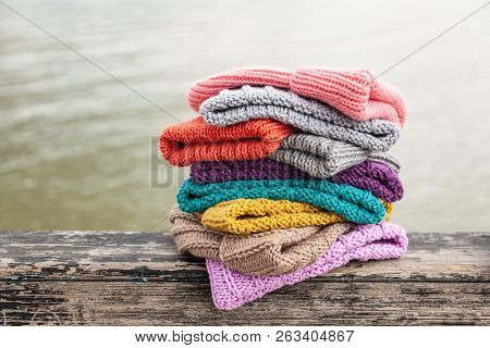 Rows Of  Colorful Knitted Hats For Sale On  Natural Background. A Colourful Collection Of Bobble Hat