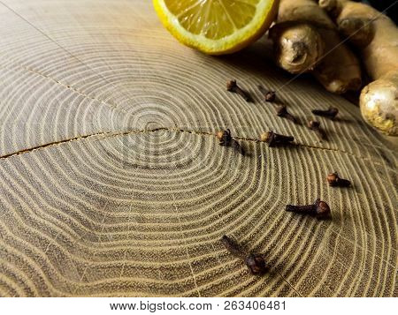 Lemon, Ginger And Cloves On Wooden Table. Healthy Drink