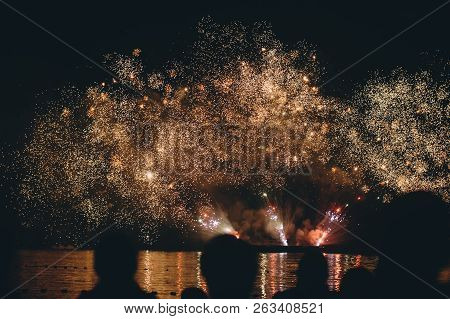 Fireworks Festival In Nysa. Many Silhouettes Of People In Front Of The Lake.