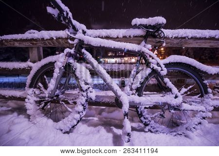 end of biking season.parked bicycle covered by snow from a heavy snowstorm.Winter cycling