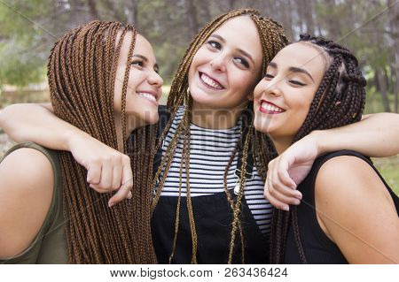Three Young And Beautiful Girls, With Braided Hair, Having Fun