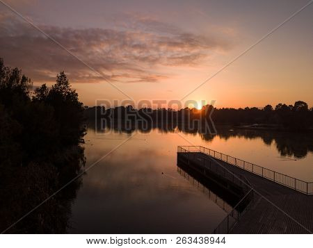 Pretty Sunrise On The Lake, With Birds Roosting On Timber Jetty In Outer Western Sydney