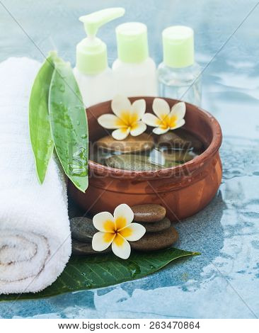 Spa Objects And Cpsmetics For Massage Treatment On Blue Background.