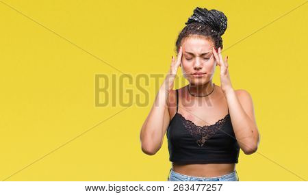 Young braided hair african american with pigmentation blemish birth mark over isolated background with hand on head for pain in head because stress. Suffering migraine.