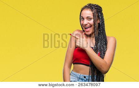 Young braided hair african american with pigmentation blemish birth mark over isolated background cheerful with a smile of face pointing with hand and finger up to the side with happy and natural 