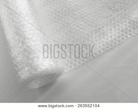 Transparent Bubble Wrap Roll For Packaging Fragile Items On White Background, View From Above