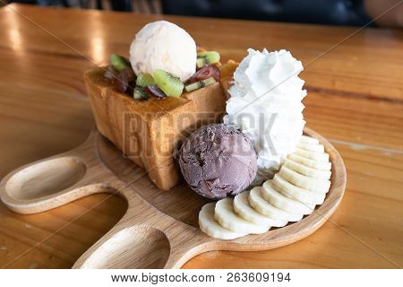 Oney Toast Topped With Condensed Milk On Wood Table