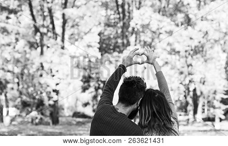Couple In Love Shows Heart Sign With Fingers.