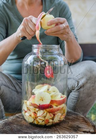 Woman Makes Apple Vinegar - Peeling Apple And Cut It Into A Bottle