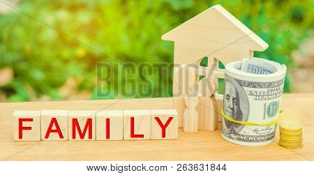 The Family With Money Is Standing Near Their House. Concept Of Wealth Life And A Happy Well-endowed.