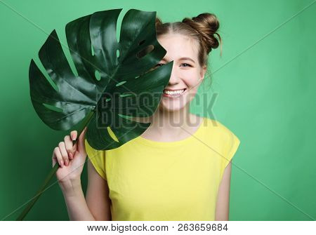 lifestyle and people concept: young woman with a leaf