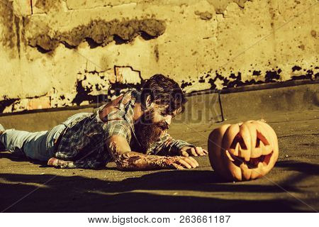 Bearded Zombie Man With Beard Creepy Vampire Or Bloody War Soldier With Wounds And Red Blood Lies On