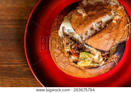 Meat Stew Served In Bread Bowl On Plate