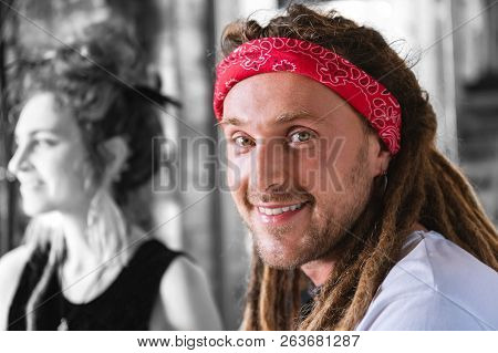 Appealing Beaming Green-eyed Man Wearing Red Head Band Chilling In The Bar