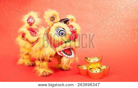 chinese traditional dancing lion with Gold ingot,Chinese calligraphy Translation:good bless for money