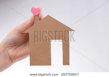 Hand Holding A Aper House On A Canvas Background