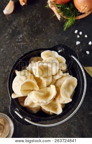 Dumplings Jiaozi, Dimsum, Momo or Ha Gao on Dark Background. Asian Food of Dough Based on Flour Stuffed with Meat, Fish, Vegetables, or Sweets