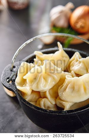Dumplings with Blueberries. Berriesjiaozi, Dimsum, Momo or Ha Gao on Dark Background. Asian Food of Dough Based on Flour Stuffed with Meat, Fish, Vegetables, or Sweets