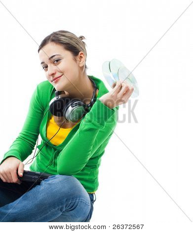 happy teenage girl with earphones and CDs