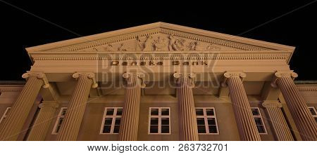 Facade And Pediment At Night Of The Danish Bank In Copenhagen With Big Columns In Ionic Order And A 