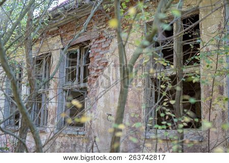 A Broken Window In An Old Abandoned Building. Broken Glass On The Window Site. Old Building.