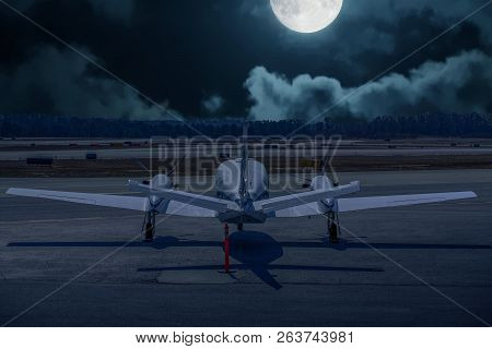 A Large White Prop Driven Plane On Tarmac From Rear