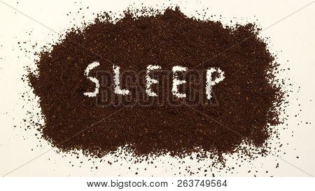 Sleep Spelled Out In Ground Coffee On White Background.