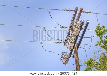 Electric Power Pole With Three Wires And Blue Sky