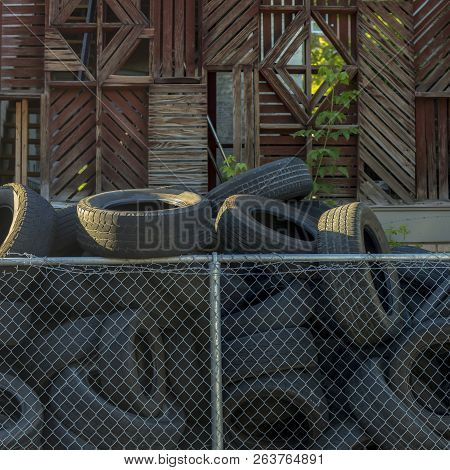 Pile Of Discarded Black Tires On A Sunny Day