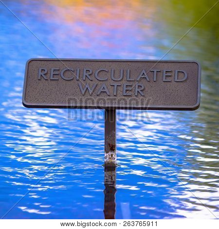Recirculated Water Sign On Reflective Blue Water