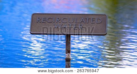 Recirculated Water Sign On Shiny Blue Water