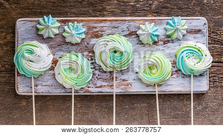 Colored Meringues On A Wooden Background. Traditional French Sweets. Web Food Banner