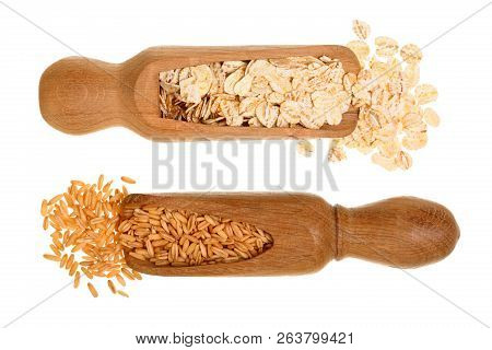 Oat Grains And Oat Flakes In Wooden Scoop Isolated On White Background. Top View. Flat Lay