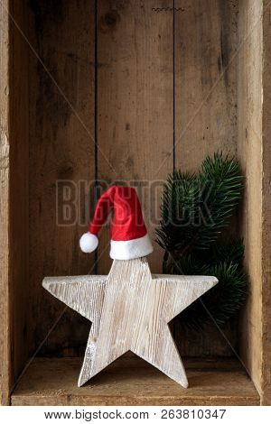 Christmas decoration Santa Clause hat on a star in a wooden box background