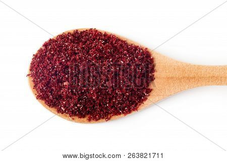 Ground Sumac Spice Powder In Wooden Spoon Isolated On White Background