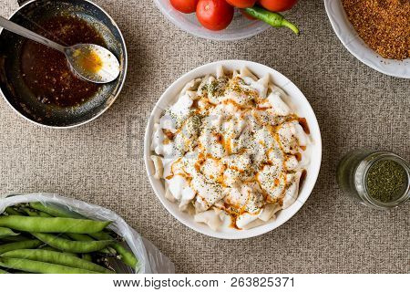 Turkish Manti Manlama / Ravioli With Yogurt And Fried Butter Sauce.
