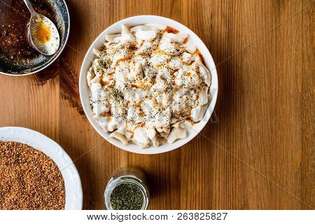 Turkish Manti Manlama / Ravioli With Yogurt And Fried Butter Sauce. Copy Space.