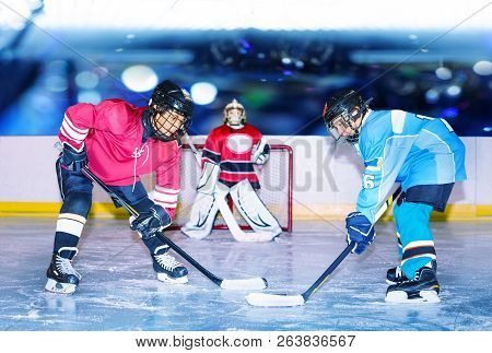 Young Hockey Defenseman In Action On Ice Rink