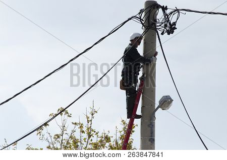 Athens, Acharnes, Stratopaido Kapota/ Greece - October 18 2018: Electrician Technician Worker Cut Ca