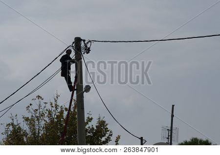 Athens, Acharnes, Stratopaido Kapota/ Greece - October 18 2018: Electrician technician worker cut ca