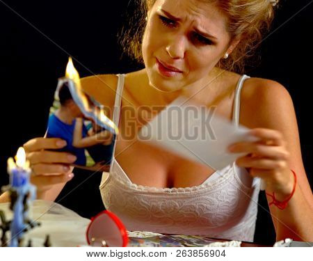 Burning photography kissing newlywed. Wedding memories. Broken heart woman. Couple break up. Sad bride on unhappy wedding. Woman and groom quarrel. Portrait crying female. Family has divorce