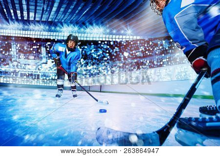Ice Hockey Player Passing The Puck To Teammate