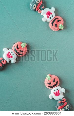 Halloween Candies Arranged In An Alternating Pattern On An Colored Background