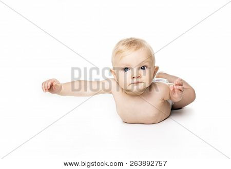Cute Baby With Beautiful Blue Eyes On The White Flooor