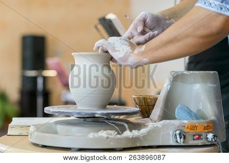 Creating A Jar Or Vase Of White Clay Close-up. Master Crock. Man Hands Making Clay Jug Macro. The Sc