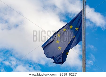 Europiean Union And Brexit, Eu Blue Flag With Yellow Stars On Blu Sky Sopy Space Close Up