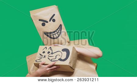 Concept Of Emotion, Gestures. A Man With A Package On His Head, With A Painted Smiley Angry, Sly, Gl