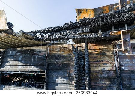 Damaged Industry Supermarket After Arson Fire With Burn Debris Of Twisted Metal Wood Structure After